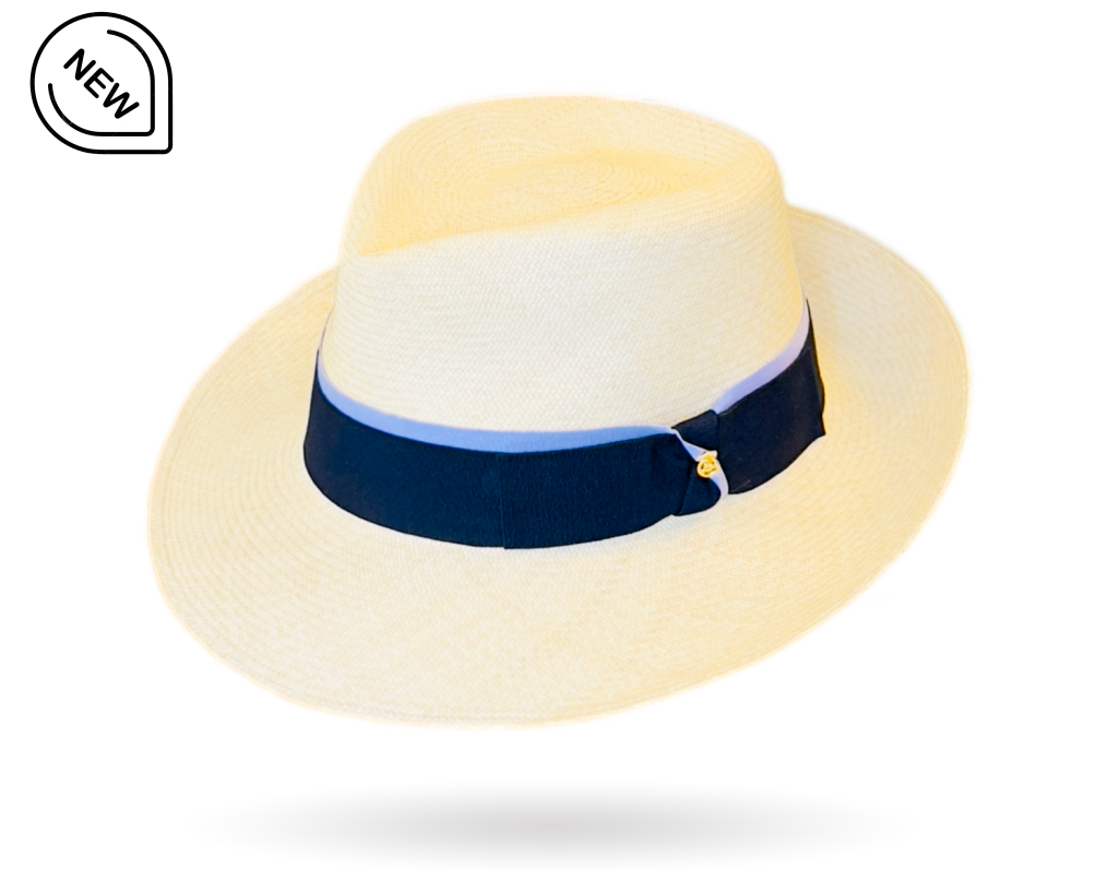 Beige straw hat with a navy blue band with gold pin